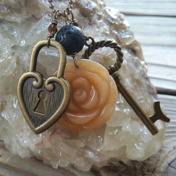 Essential oil essential oil diffuser necklace - cluster - antiqued bronz  - red agate flower, skeleton key, heart lock.