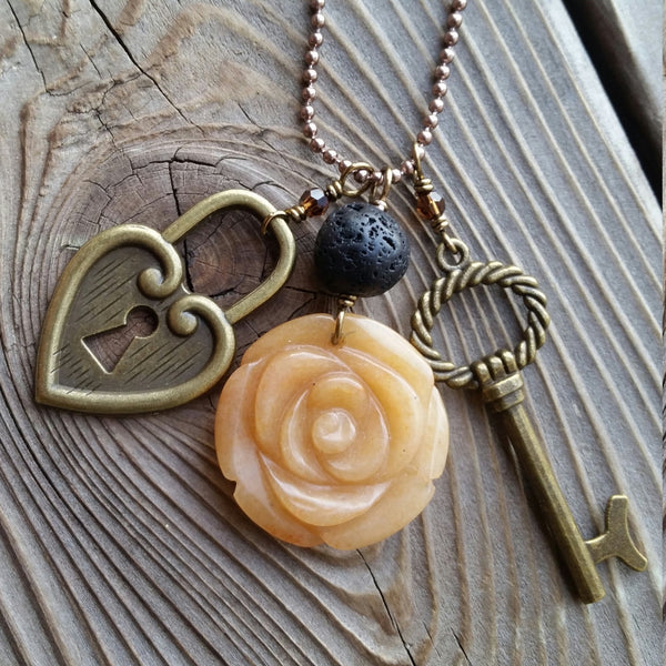 Essential oil essential oil diffuser necklace - cluster - antiqued bronz  - red agate flower, skeleton key, heart lock.