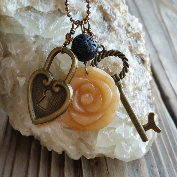 Essential oil essential oil diffuser necklace - cluster - antiqued bronz  - red agate flower, skeleton key, heart lock.