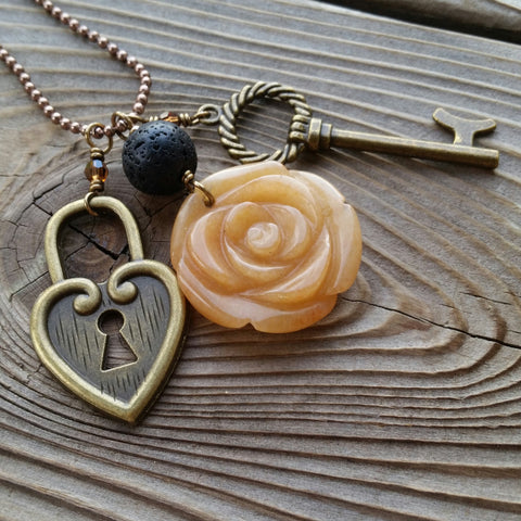 Essential oil essential oil diffuser necklace - cluster - antiqued bronz  - red agate flower, skeleton key, heart lock.